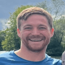 smiling man outdoors Slack emoji